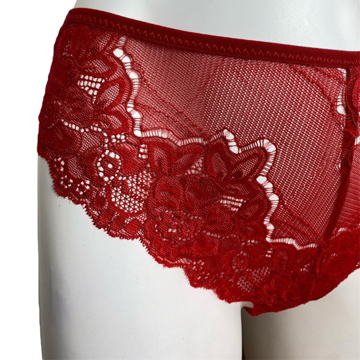 Red lace underwear on a mannequin against a white background