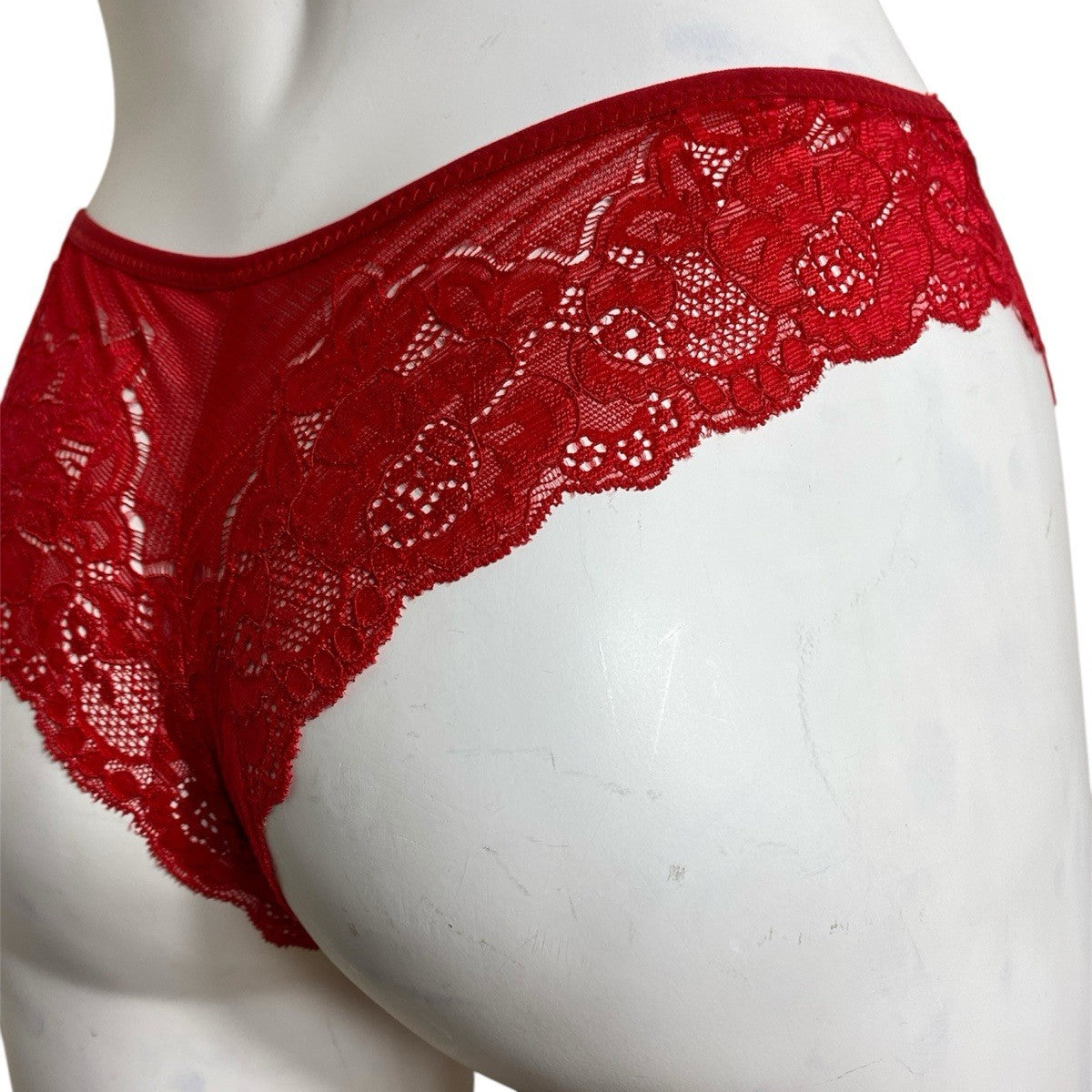 Red lace underwear on a mannequin against a white background