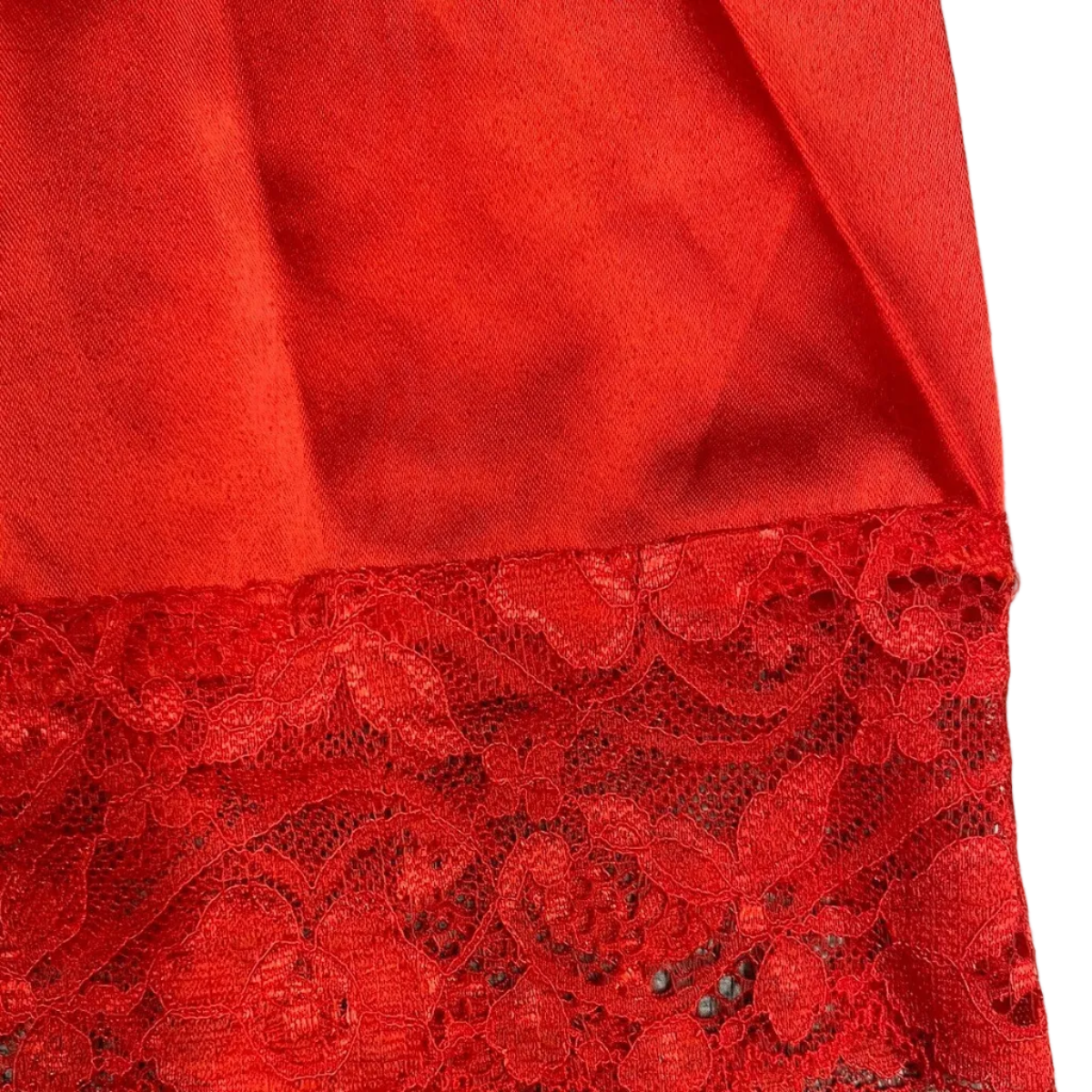 Red fabric with lace trim on a gray surface