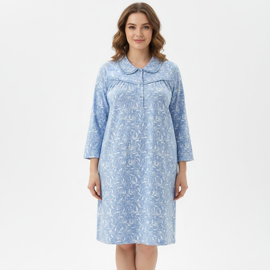 Woman wearing a blue patterned nightshirt on a white background