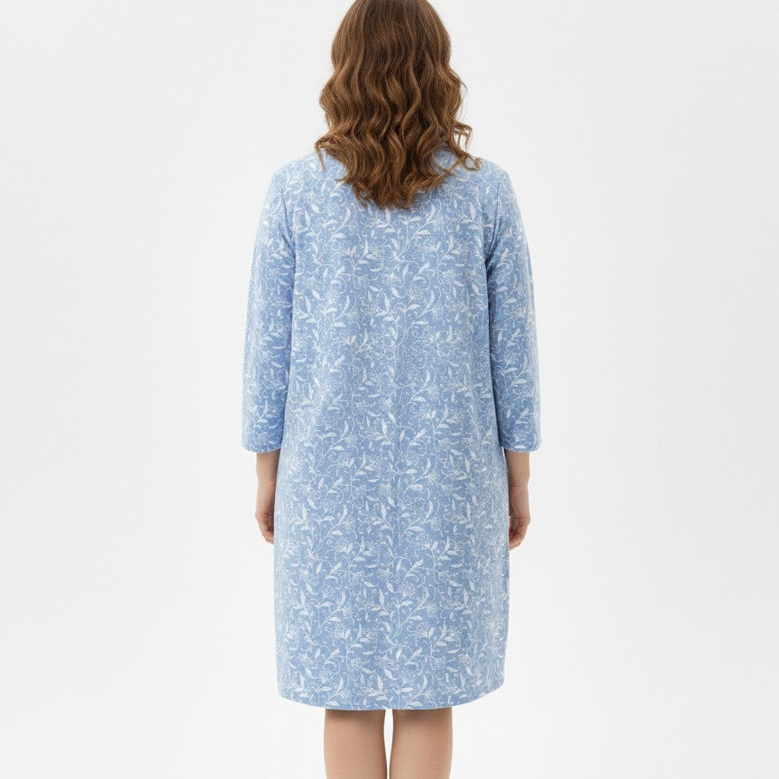 Woman wearing a blue patterned dress on a white background