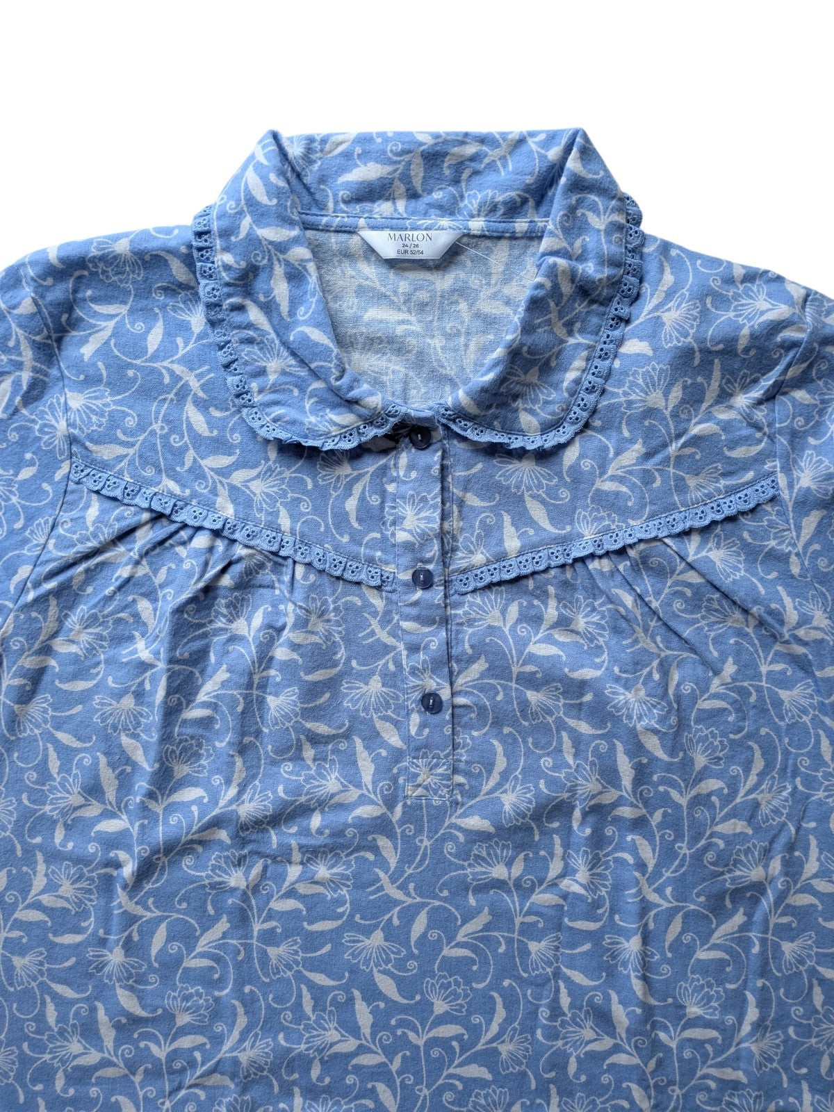 Blue floral patterned shirt on a white background