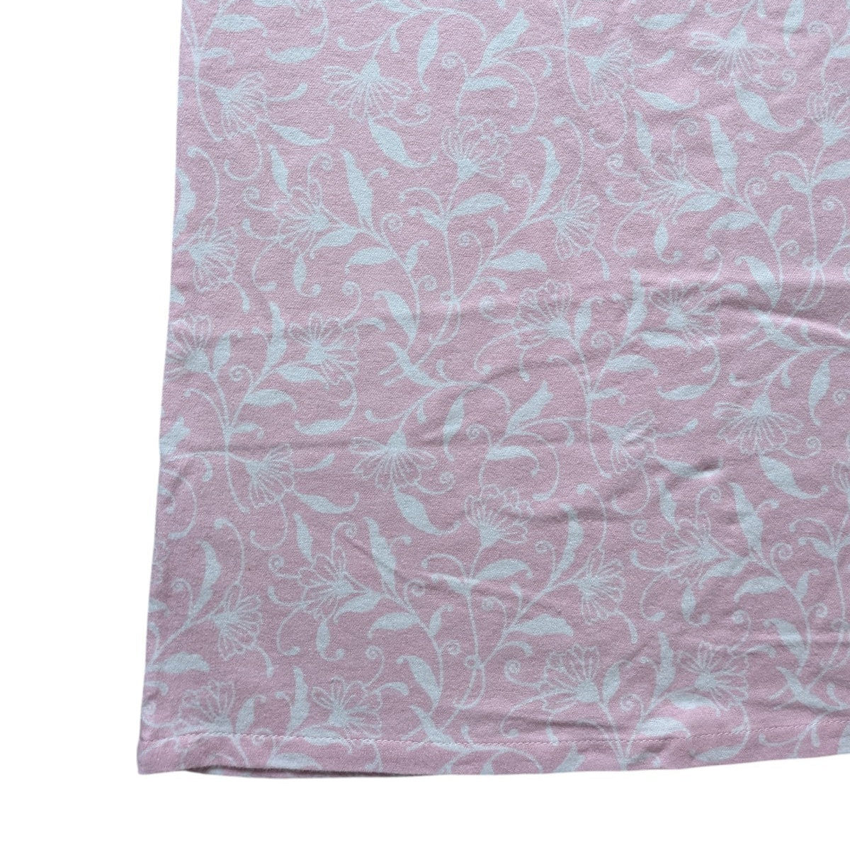 Pink fabric with light blue floral pattern on a white background